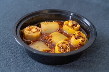 Black bowl filled with Laping rolls on a kitchen countertop