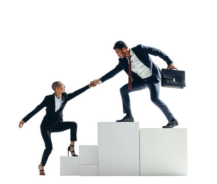 Businessman Helping His Partner Get To The Top Of A Block Of Stairs On A Transparent Background