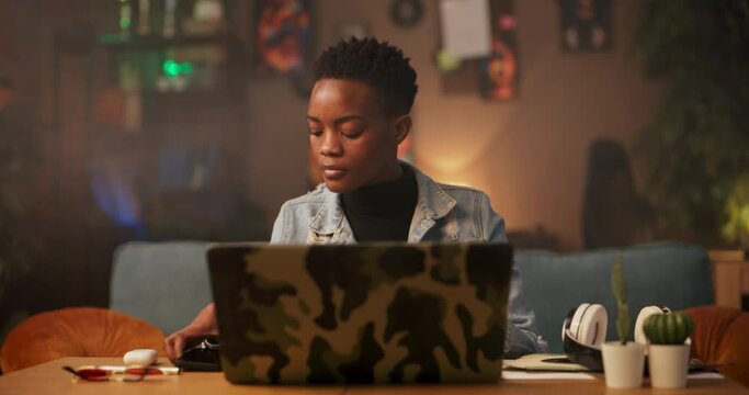 Business consultant or strategist meeting clientsAfrican woman in the living room finalizes her work on the computer, quickly grabs her laptop heads out attending important meetings.