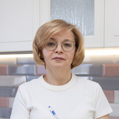 Beautiful middle-aged woman with glasses looking at camera