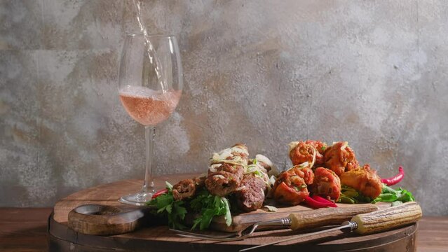 BBQ party, pouring rose wine in a glass