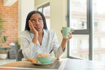 black afro woman feeling bored, frustrated and sleepy after a tiresome. breakfast concept