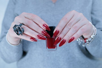 Woman hand with long nails and a red nail polish 