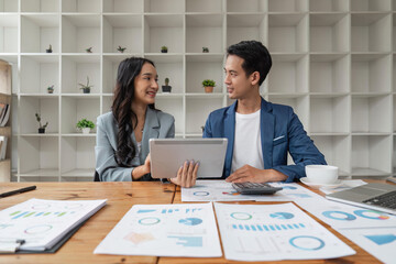 Two business people talk project strategy at office meeting room. Businessman discuss project planning with colleague at workplace while having conversation and advice on financial data report