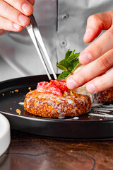 chef hand decorated cheese pancakes with ice cream and sweet sauce