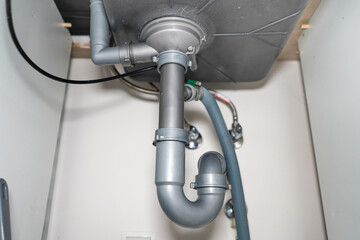 Plumbing instalation of the sink. Pipes under the sink. Plumbing.