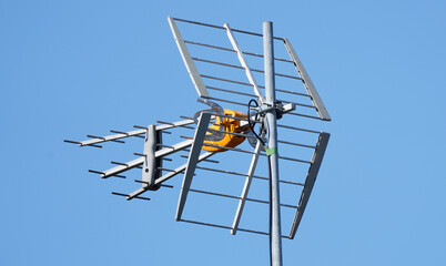 TV Antenna on the roof. Aerial installed to the roof. Receiving tv signals. Tv and internet connection aerial.