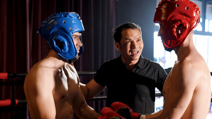 Two Caucasian boxers, Red and Blue are fighting. A boxing referee discusses the rules of a boxing...