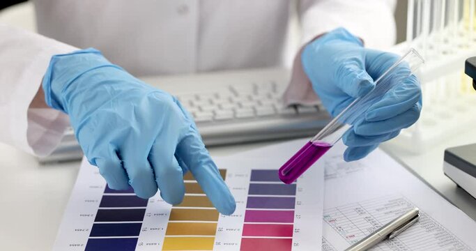 Woman chemist holding test tube and typing on keyboard 4k movie. Chemical industry concept