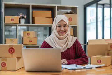 Beautiful muslim woman in hijab doing online shopping in office