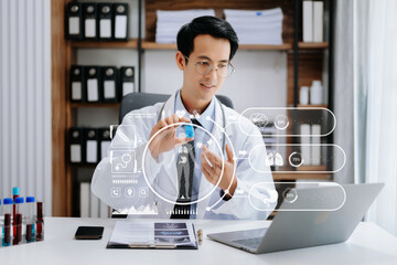 medical technology concept,smart Asian doctor hand working with modern laptop computer with his...