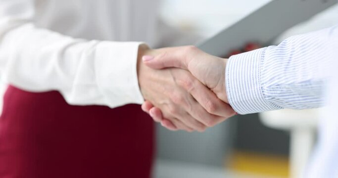 Businesswoman giving her hand to partner for handshake 4k movie. Teamwork in business concept
