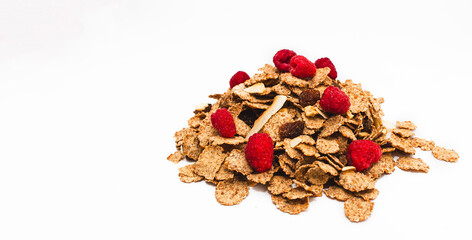 Muesli from various cereals with raspberries, raisins, coconut on a white background