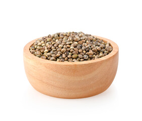 Heap of hemp seeds in wooden bowl on white background.