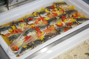 Prepared fish in a big tray on a buffet line