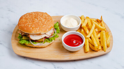 Chicken hamburger and fries on tray