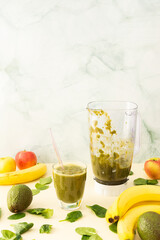 Healthy breakfasts, healthy tasty smoothie of spinach and banana and avocado, boiled broccoli and pea protein and mixed greens, smoothie jar mixer
