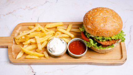 Beef burger and fries on tray