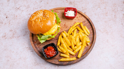 Cheeseburger with fries on tray