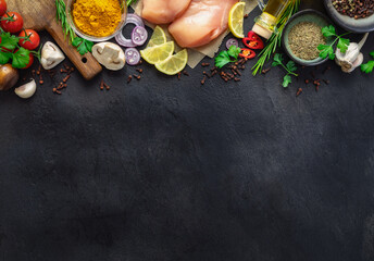 Food cooking ingredients background with fresh vegetables, chicken breast, herbs, spices and olive...