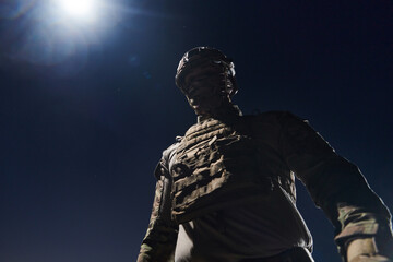 Fototapeta premium A professional soldier in full military gear striding through the dark night as he embarks on a perilous military mission