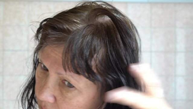 damaged messed up hair with gray hair in an elderly woman.