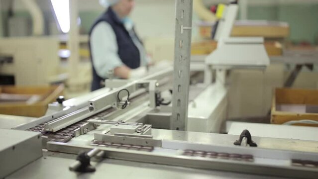 static medium shot of conveyor line with classic chocolate bars in a chocolate factory