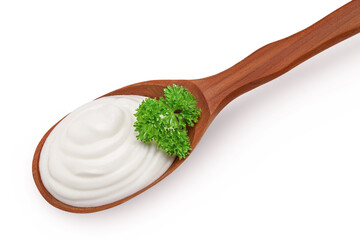 sour cream or yogurt in wooden spoon with parsley onion isolated on white background with full...