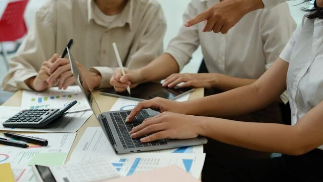Slow motion shot of business people discussing over new business project and planning marketing strategy at co working space