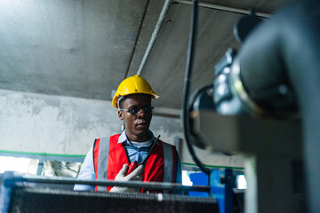 Fototapeta premium professional technician engineer with safety working in industrial manufacturing factory, checking equipment of machinery production technology or construction operating workshop maintenance service