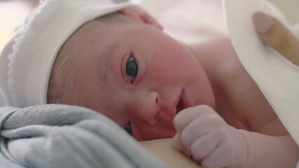 Newborn baby lying on mothers chest
