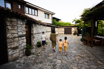 Fototapeta na wymiar Family walking in the street of old town of Nessebar, Bulgaria.