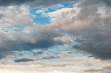 Cumulus clouds and gaps of clear blue sky.