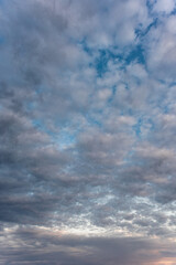 Cirrocumulus clouds and gaps of blue sky.