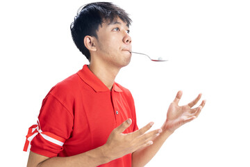 Indonesian men celebrate Indonesian independence day on 17 August with a marbles race using a spoon