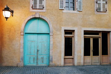 front view of and Authentic old house with wooden door and glass window, hanging light on the wall