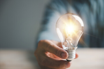 Conceptual image of a man with a light bulb, illustrating the power of creative thinking,...