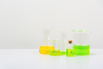 some test tube on the white table  with beakers, flasks, and test tubes filled with colorful liquids