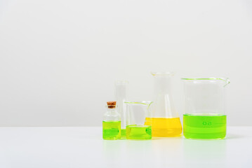some test tube on the white table  with beakers, flasks, and test tubes filled with colorful liquids