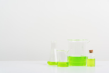 some test tube on the white table  with beakers, flasks, and test tubes filled with colorful liquids