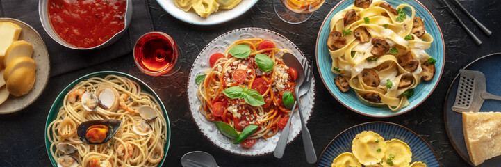 Pasta variety panorama on black. Italian food and drinks, overhead flat lay shot. Spaghetti marinara, mushroom pappardelle, seafood pasta, wine