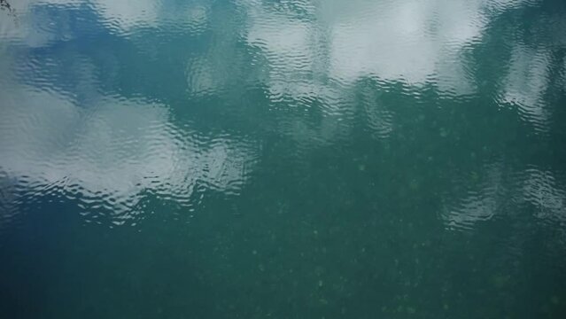 close up background of a beautiful reflecting water surfaces with soft waves. 