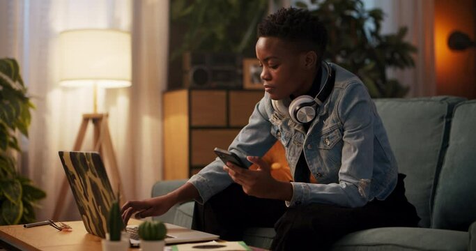 Web developer software engineer African woman typing with purpose on laptop working coding designing websites developing software applications showcasing technical skills problem-solving abilities.