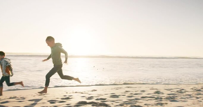 Beach, happy and children running for a race, fun competition or exercise together on holiday. Playful, fitness and kids at the sea for cardio, playing and crazy on a vacation in summer for fitness