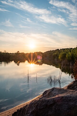 Behold the awe-inspiring beauty of nature as a stunning landscape unveils before your eyes. A colorful sunset paints the sky with vibrant hues of red and gold, casting a breathtaking reflection over a