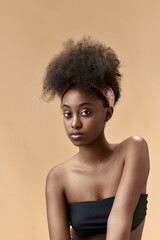 Tenderness. Portrait of young, beautiful, african woman with well-kept, health skin posing in top against studio background