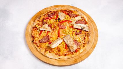 Spicy sausage and chicken pizza isolated