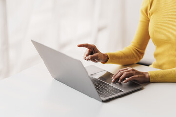 Fototapeta premium Close-up portrait typing keyboard on laptop computer. Working online on white table at office. Facebook chat. Website meeting. Blogger. Journalist writing articles. online job ideas