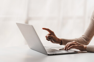 Fototapeta premium Close-up portrait typing keyboard on laptop computer. Working online on white table at office. Facebook chat. Website meeting. Blogger. Journalist writing articles. online job ideas