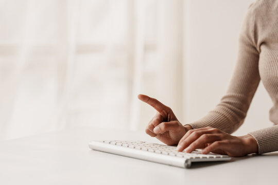 Close-up portrait typing keyboard on laptop computer. Working online on white table at office. Facebook chat. Website meeting. Blogger. Journalist writing articles. online job ideas